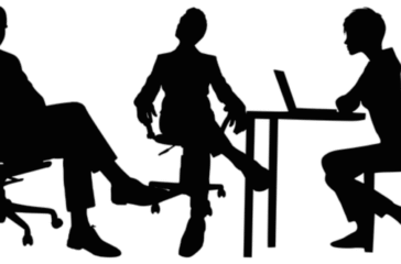 Concentric Advisors Interview A group of professionals conducting an interview in a modern office setting, with one candidate being interviewed by a panel of interviewers. The image conveys a formal and professional atmosphere, highlighting the interview process at Concentric Advisors.